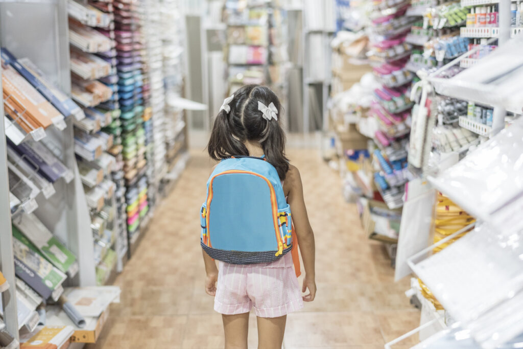 alon little girl in stocre with backpack ready for by school material