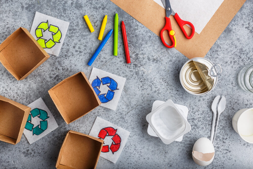 Kids hands is making recycling game kid is drawing recycle sign paper craft